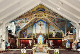 An ornately decorated Indian Cathedral features images of the crucifixion and Jesus' life