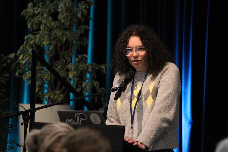 Auckland synod member Jessica Hughes speaks to Te Hīnota Whānui on an update of the prayer of thanksgiving for a child.