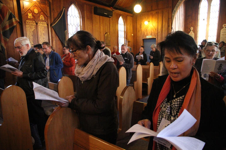 Hui members join in song at St John's Te Awamutu surrounded by memorials for Māori and Pākehā who died in the British invasion of the Waikato.