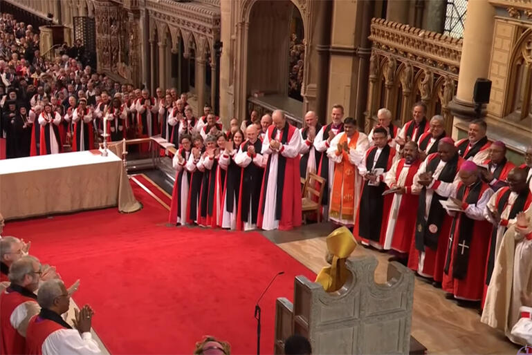 Worshippers applaud Archbishop of Canterbury Sarah Mullally after her installation on the throne of Saint Augustine. 