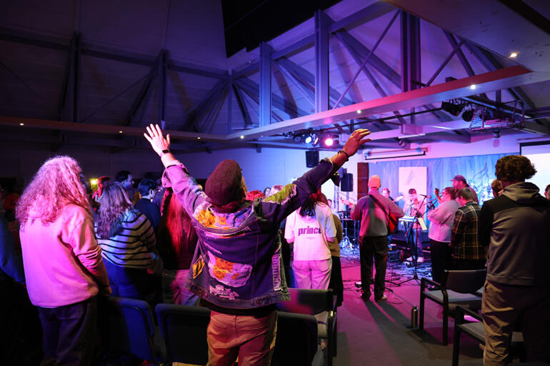 The gathering throw themselves into worship as The Abbey opens.