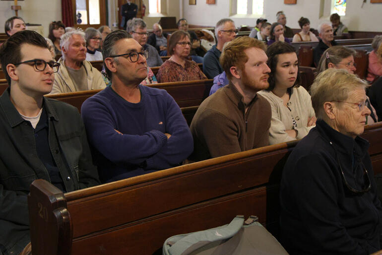 Dominic Barlow joins friends and whānau (far left) listening to the disturbing news from Cole's six months living in the West Bank.